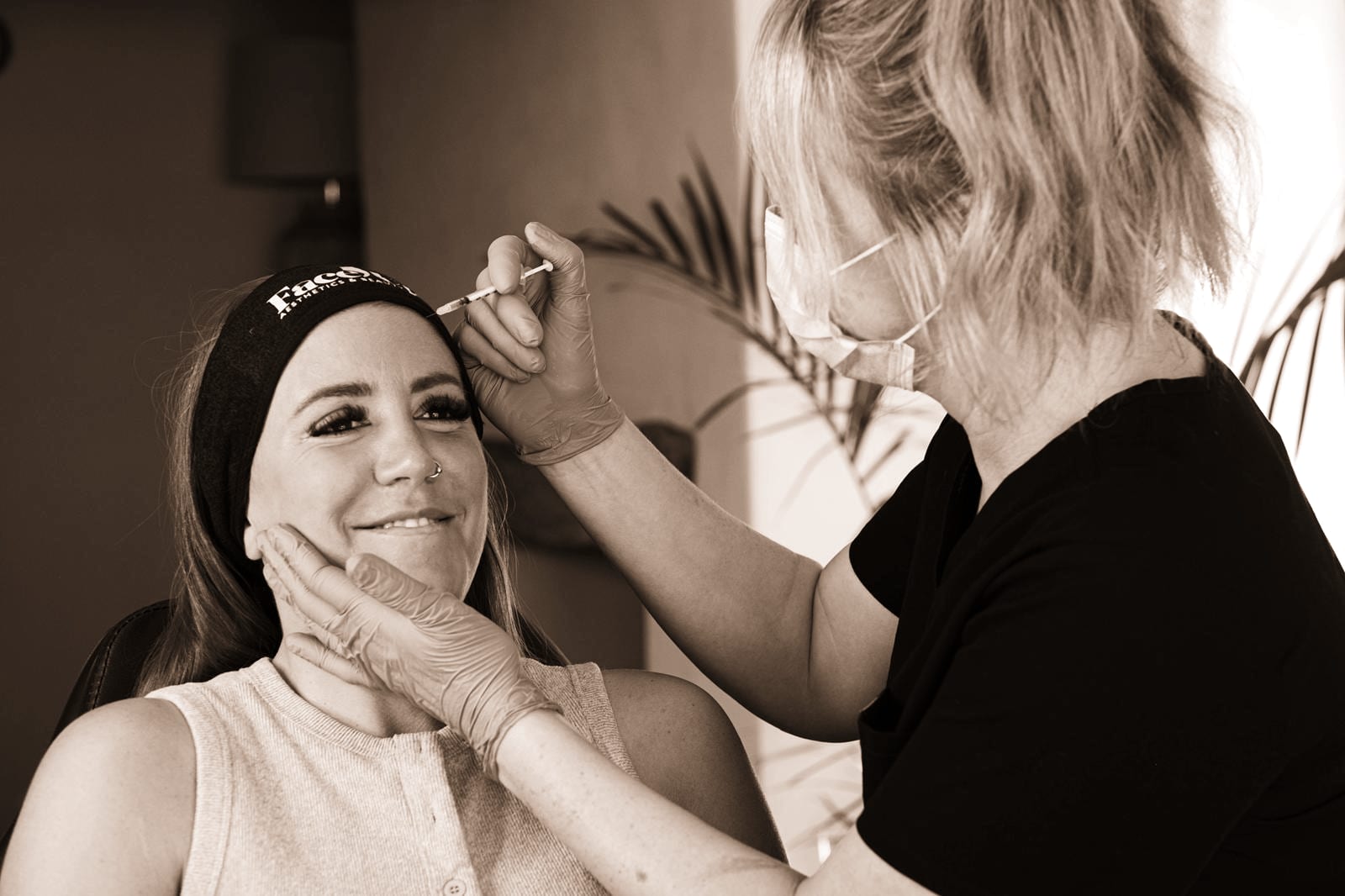 Amy carrying out an anti-wrinkle treatment on a happy client at FaceUp Aesthetics near Pocklington