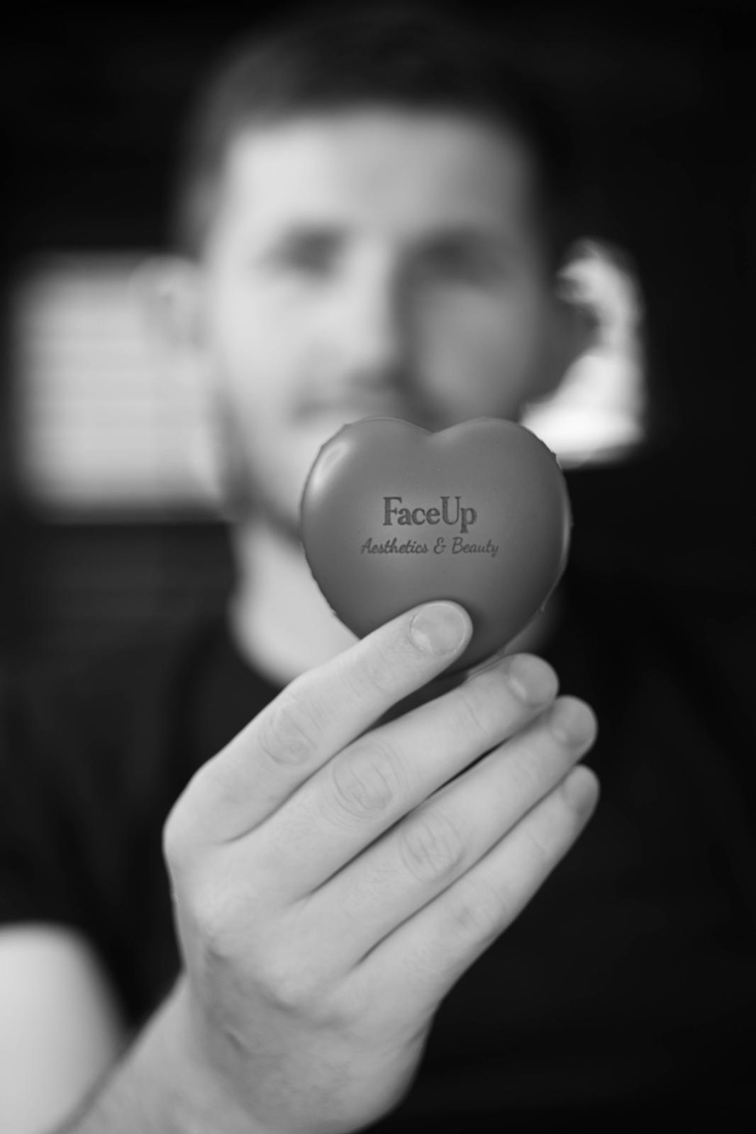 Client holding a FaceUp Aesthetics & Beauty heart — book safe, caring aesthetic treatments near Pocklington and York
